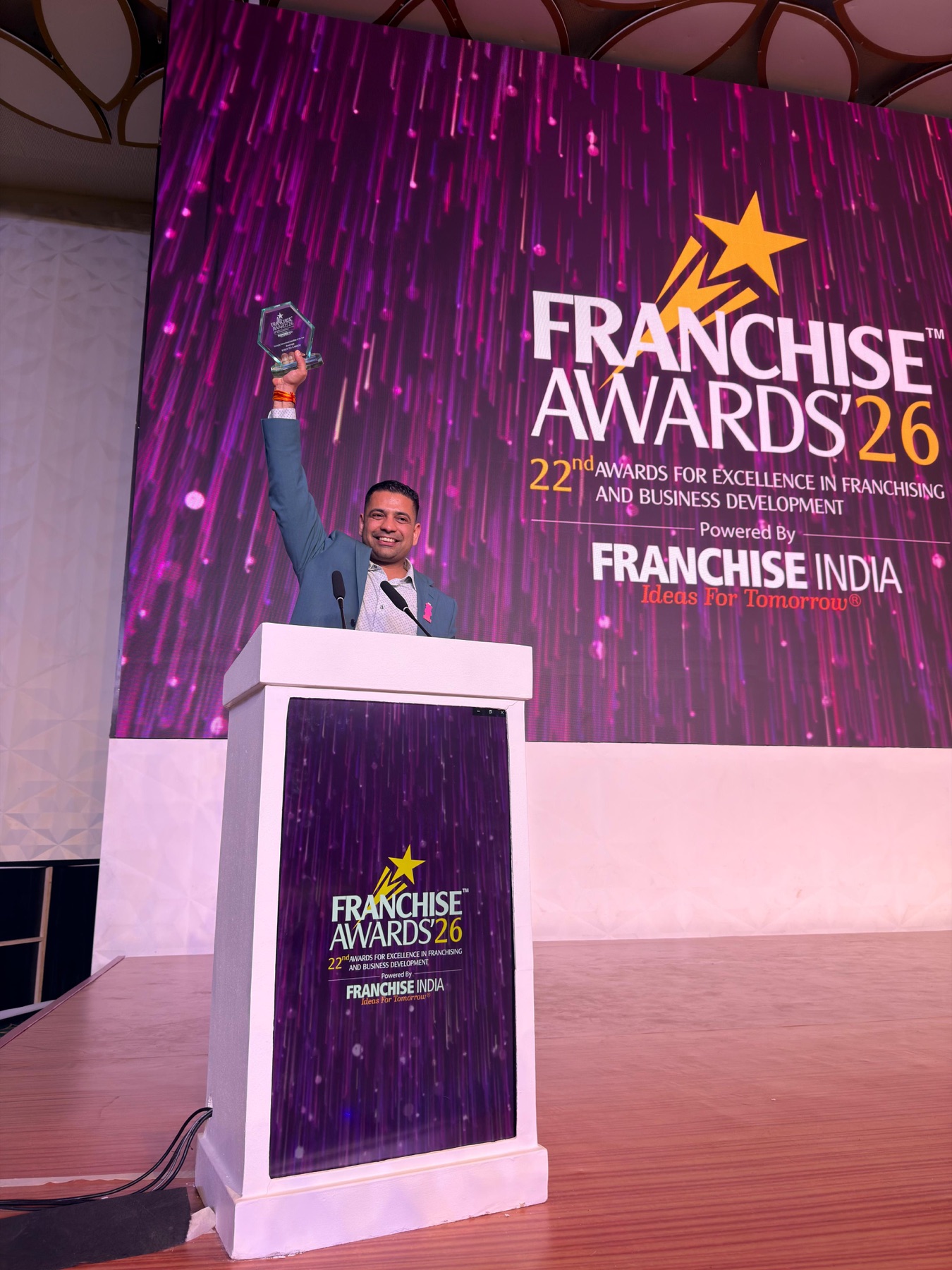 Bober Tea co-founder holding the award on the Franchise Awards 2026 stage