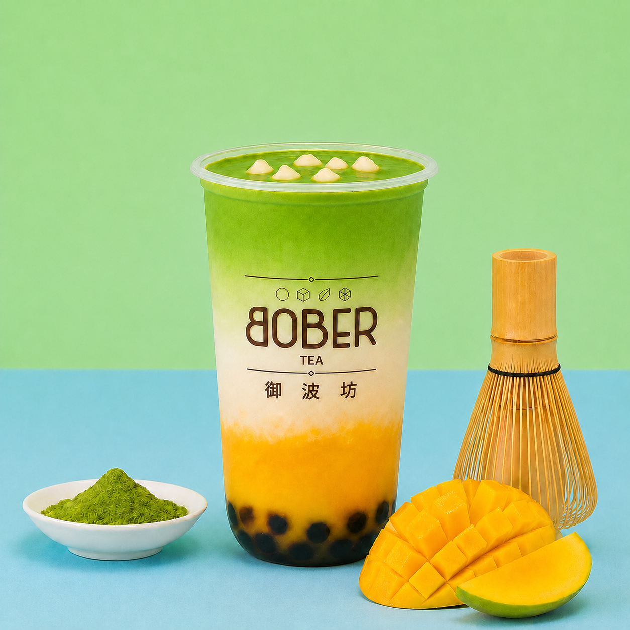 Mango Matcha drink with tapioca pearls, fresh mango, matcha powder and a bamboo whisk