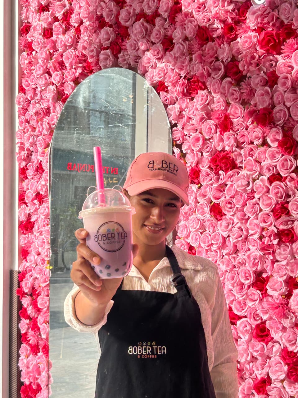 A Bober Tea team member presenting a handcrafted drink